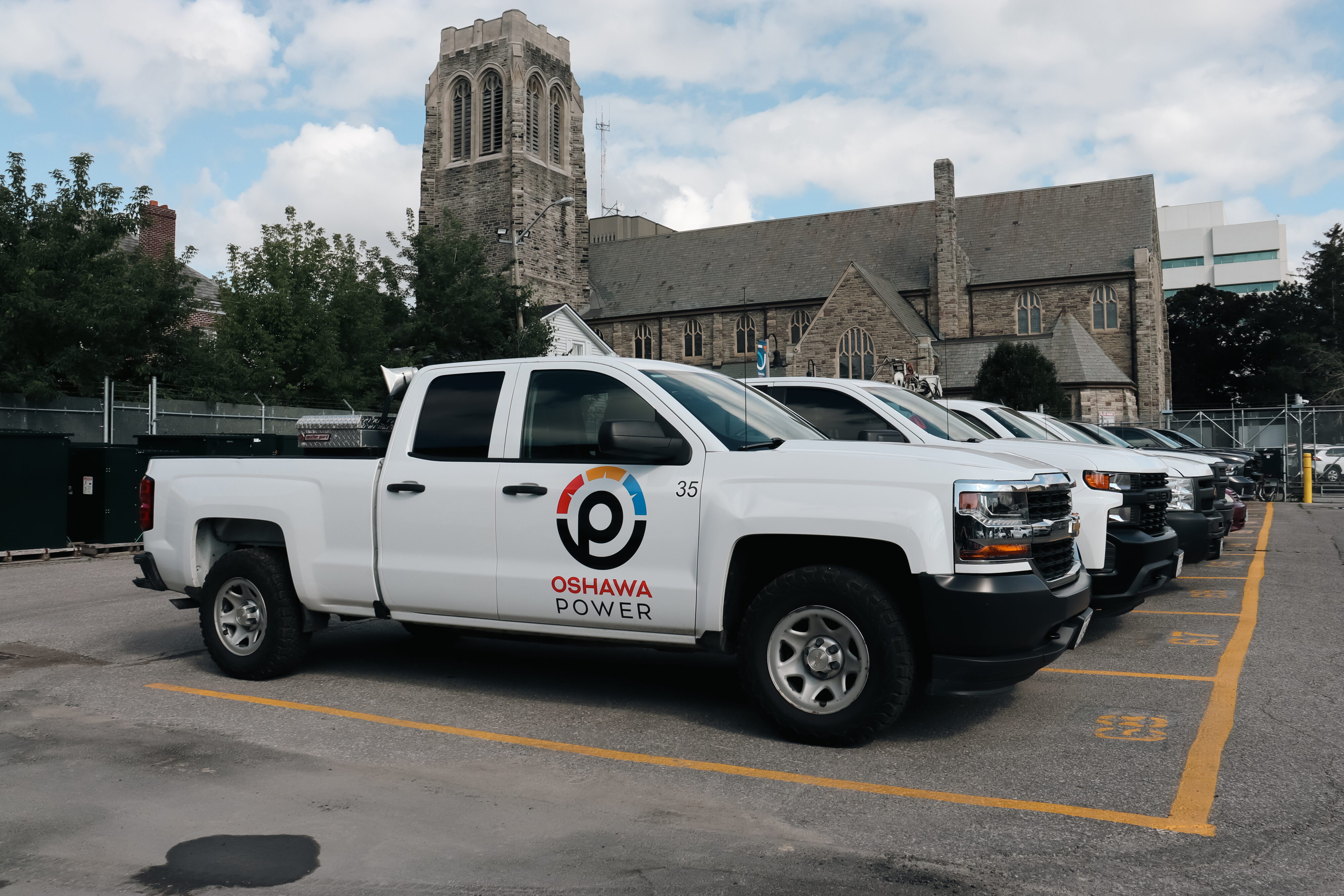 line of Oshawa Power pick up trucks