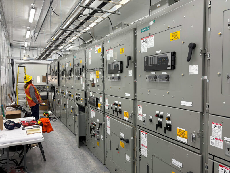 A crew member inspects the inside of Oshawa Power's new eHouse Switchgear at Municipal Susbtation #7.